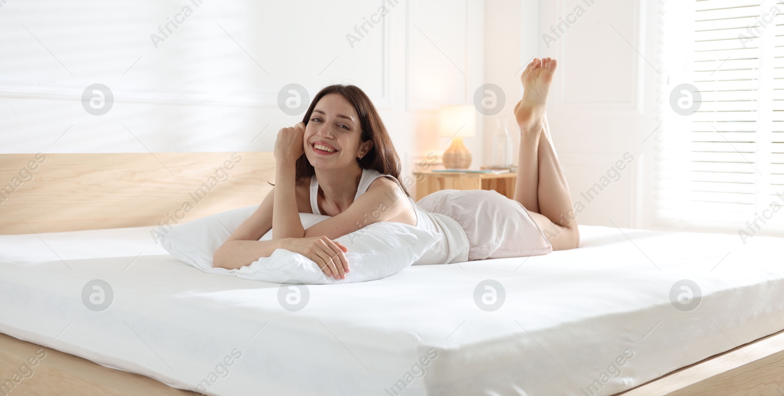 Woman lying on bed with orthopedic mattress at home Photo of Woman lying on bed with orthopedic mattress at home