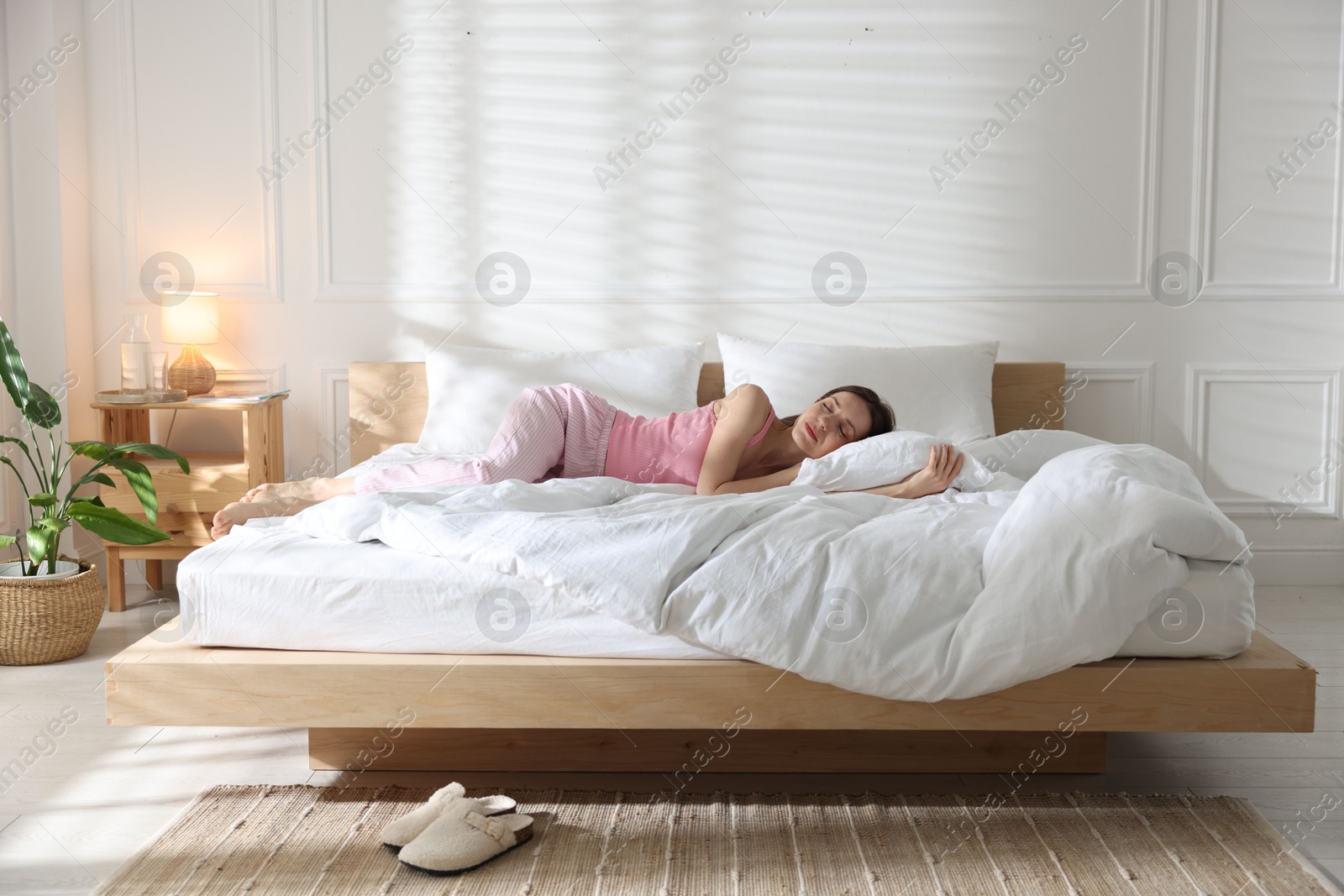 Woman sleeping on bed with soft mattress at home Photo of Woman sleeping on bed with soft mattress at home