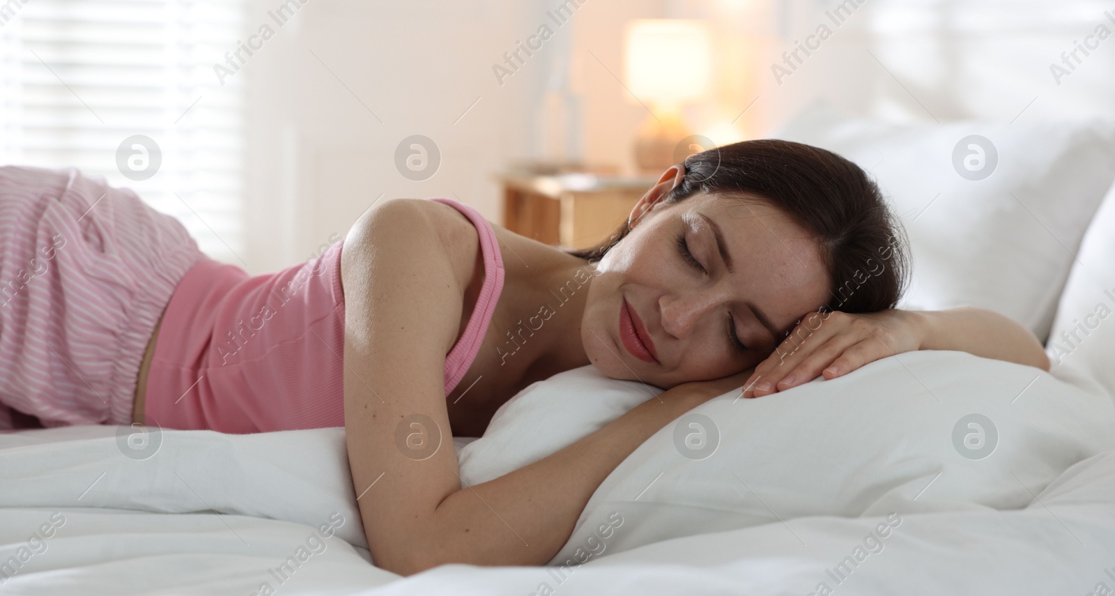 Woman sleeping on bed with soft mattress at home Photo of Woman sleeping on bed with soft mattress at home