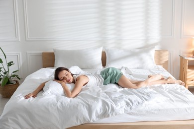 Photo of Woman sleeping on bed with soft mattress at home