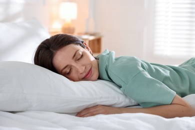 Photo of Woman sleeping on bed with soft mattress at home