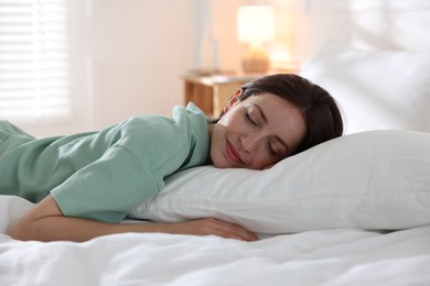 Photo of Woman sleeping on bed with soft mattress at home