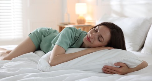 Photo of Woman sleeping on bed with soft mattress at home