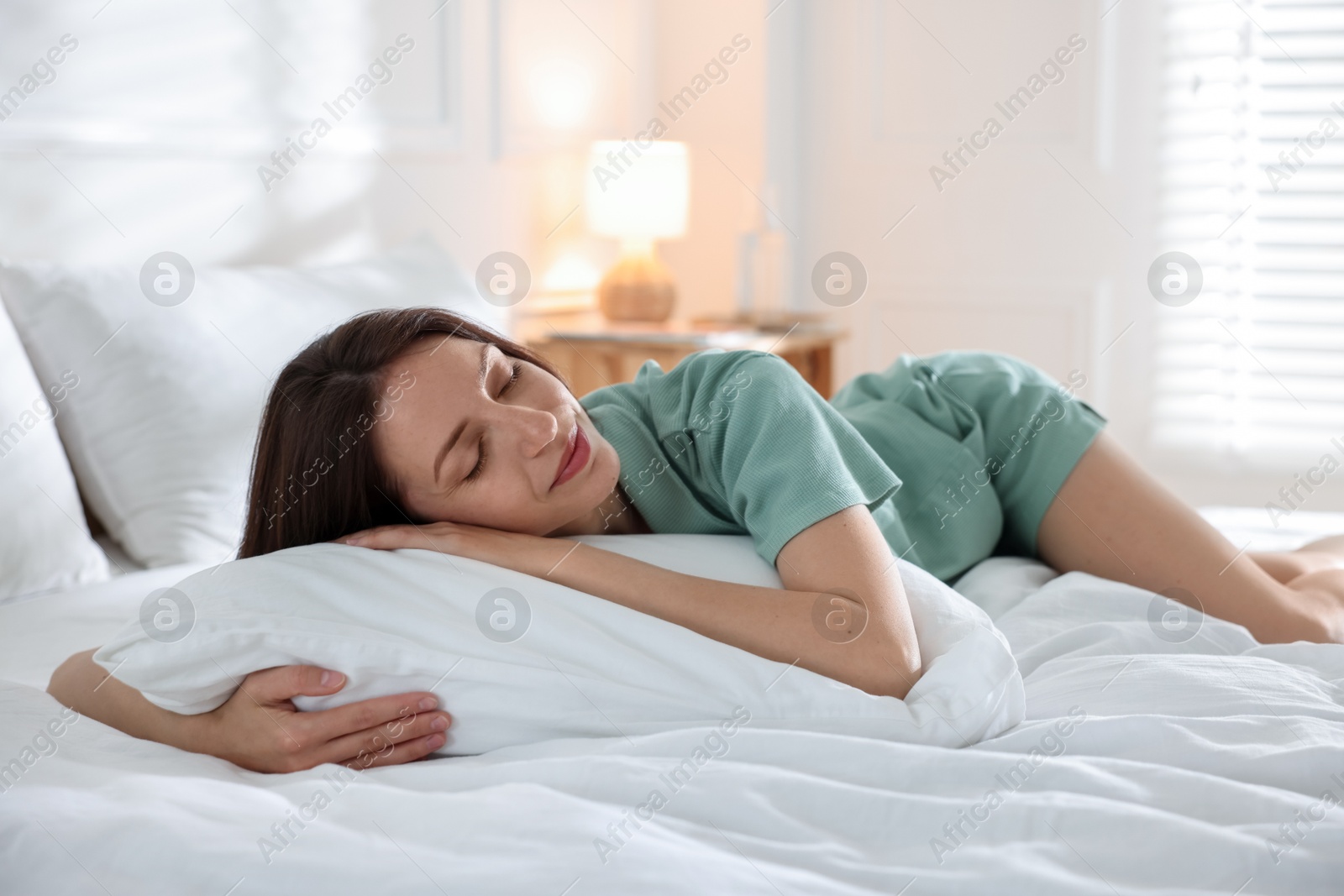 Woman sleeping on bed with soft mattress at home Photo of Woman sleeping on bed with soft mattress at home