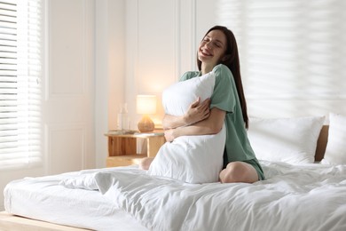 Photo of Woman on bed with soft mattress at home. Space for text