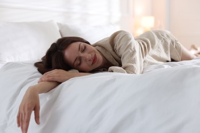 Photo of Woman sleeping on bed with soft mattress at home