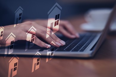 Image of Real estate agent looking for housing via laptop at table, closeup. Illustrations of buildings as home variations