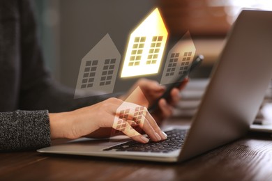 Image of Real estate agent looking for housing via laptop at table, closeup. Illustrations of buildings over device