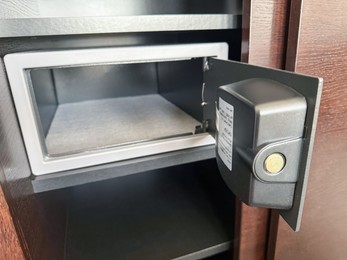 Photo of Open steel safe with electronic lock indoors, closeup
