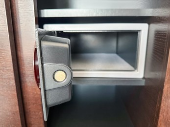 Photo of Open steel safe with electronic lock indoors, closeup