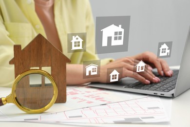 Image of Real estate agent looking for housing via laptop at table, closeup. Different buildings icons over device
