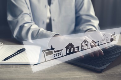 Image of Real estate agent looking for housing via laptop at wooden table, closeup. Illustrations of different buildings over device