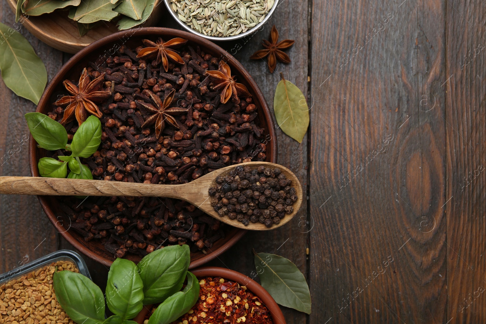 Different aromatic spices on wooden table, flat lay. Space for text Photo of Different aromatic spices on wooden table, flat lay. Space for text