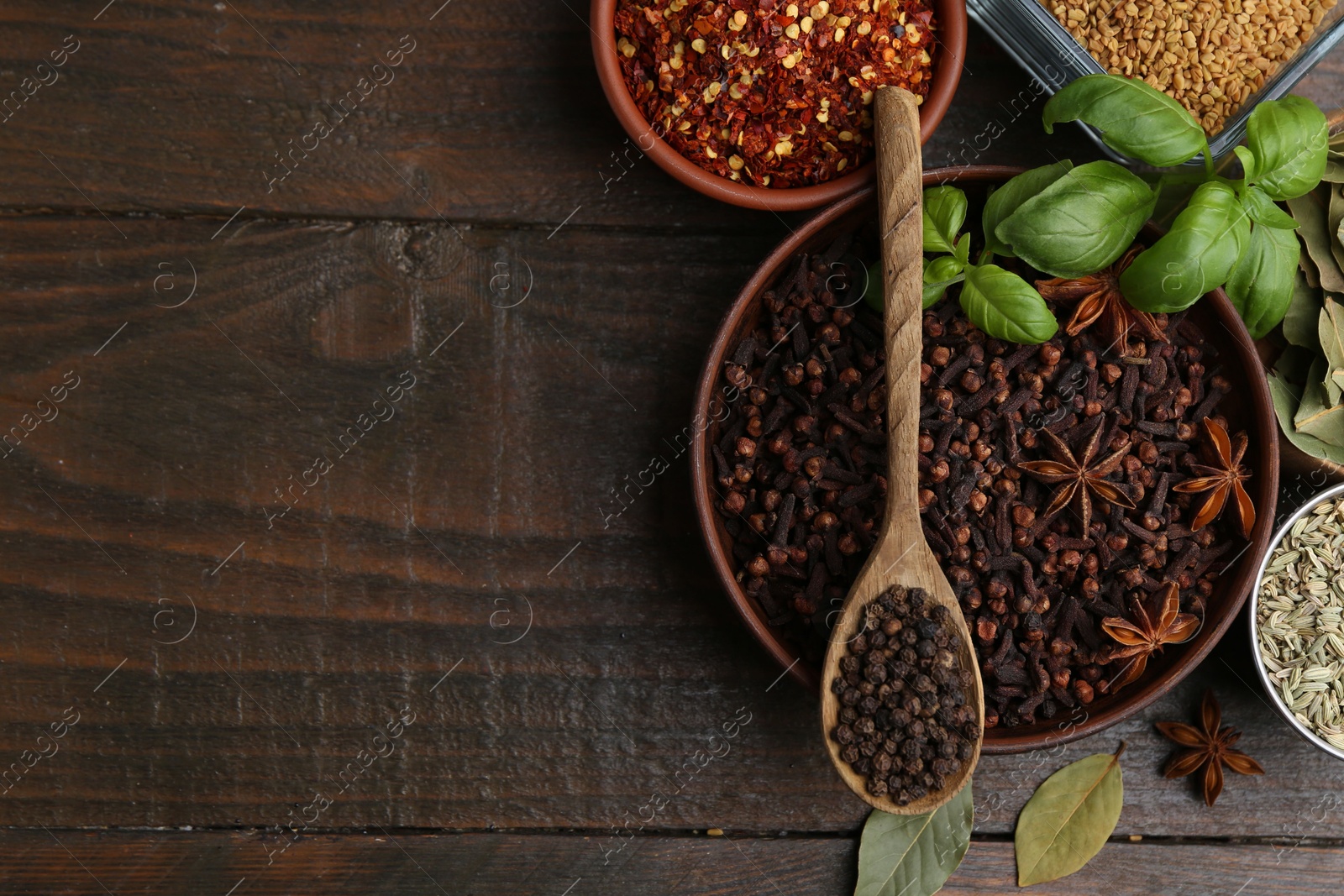 Different aromatic spices on wooden table, flat lay. Space for text Photo of Different aromatic spices on wooden table, flat lay. Space for text