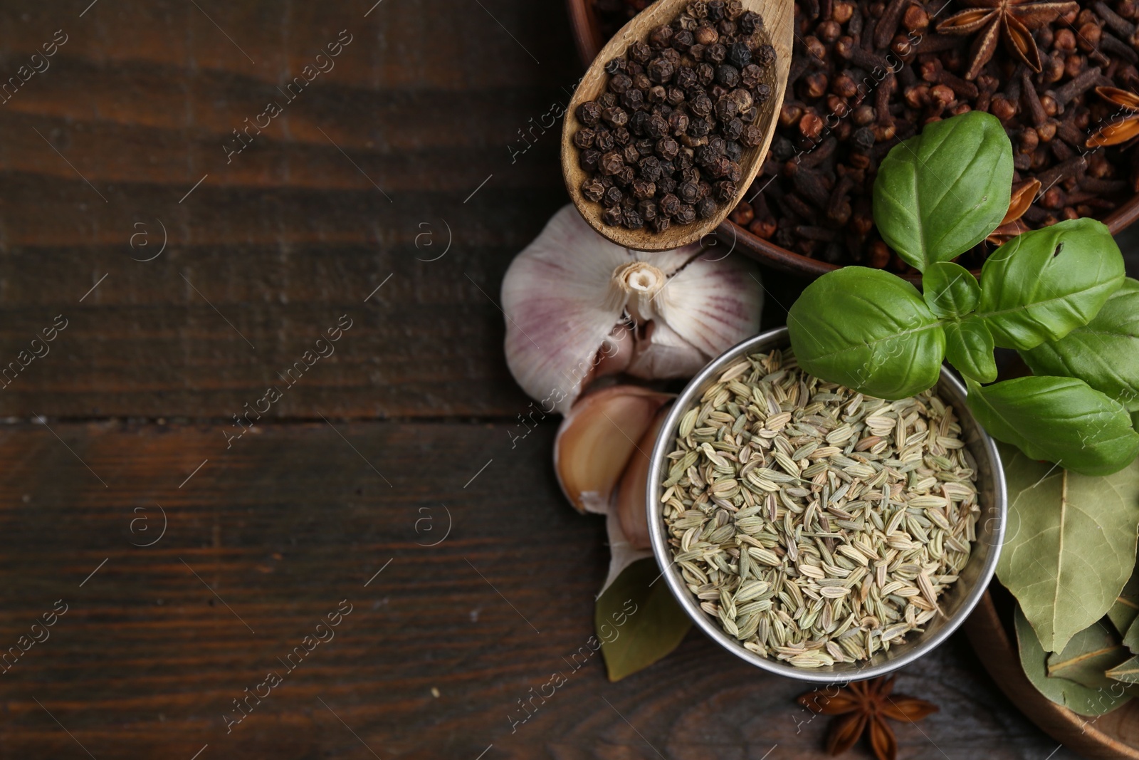 Different aromatic spices on wooden table, flat lay. Space for text Photo of Different aromatic spices on wooden table, flat lay. Space for text