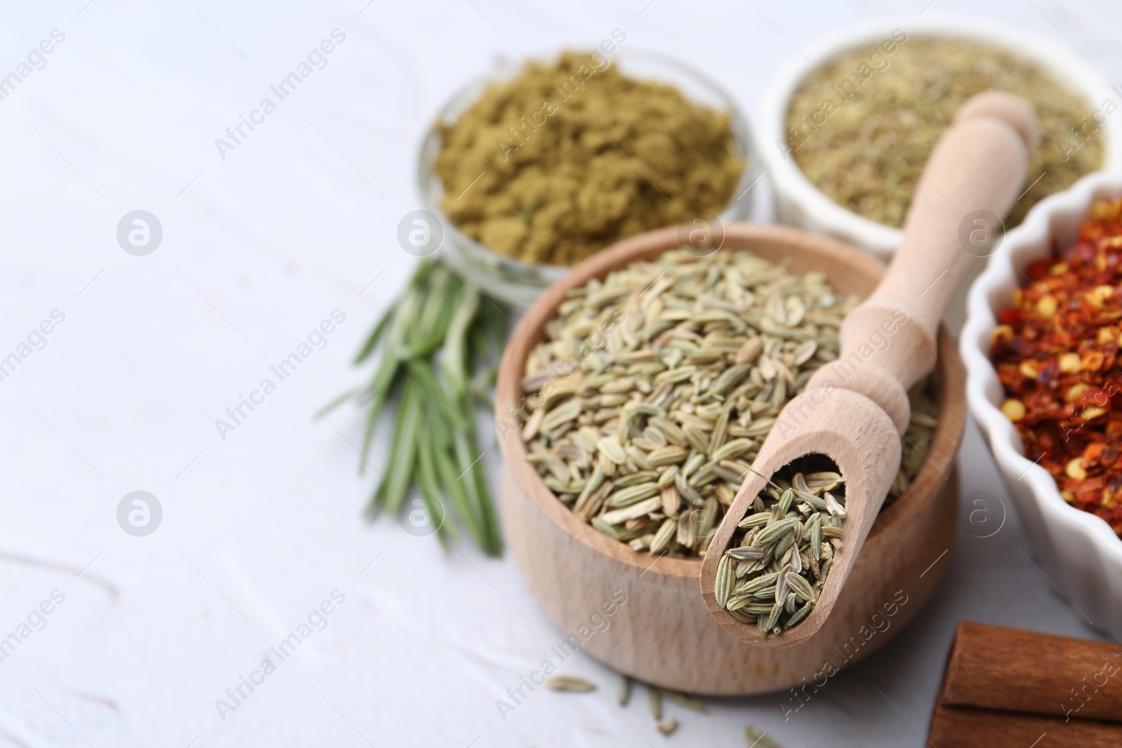 Different aromatic spices on light grey textured table, selective focus. Space for text Photo of Different aromatic spices on light grey textured table, selective focus. Space for text