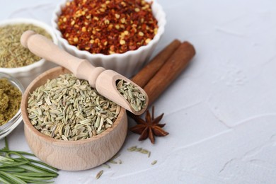 Photo of Different aromatic spices on light grey textured table, closeup. Space for text