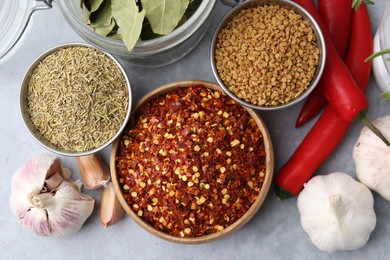 Photo of Different aromatic spices on grey table, flat lay