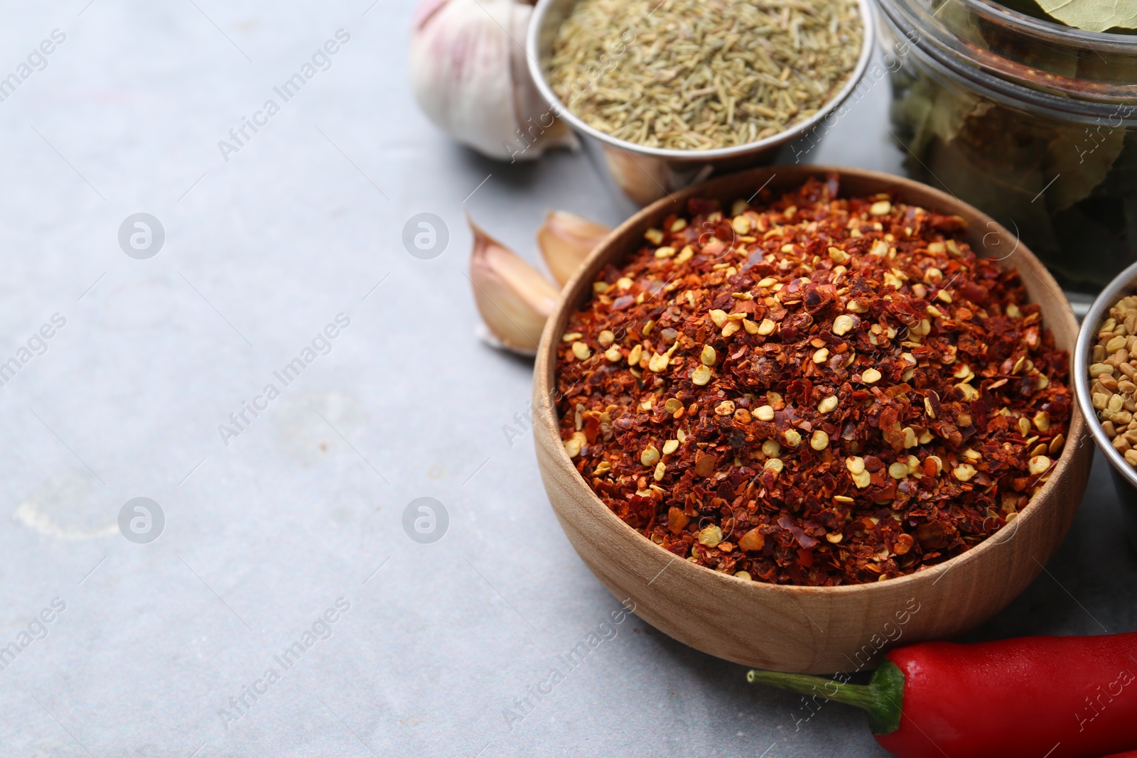 Different aromatic spices on grey table, closeup. Space for text Photo of Different aromatic spices on grey table, closeup. Space for text