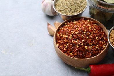 Photo of Different aromatic spices on grey table, closeup. Space for text