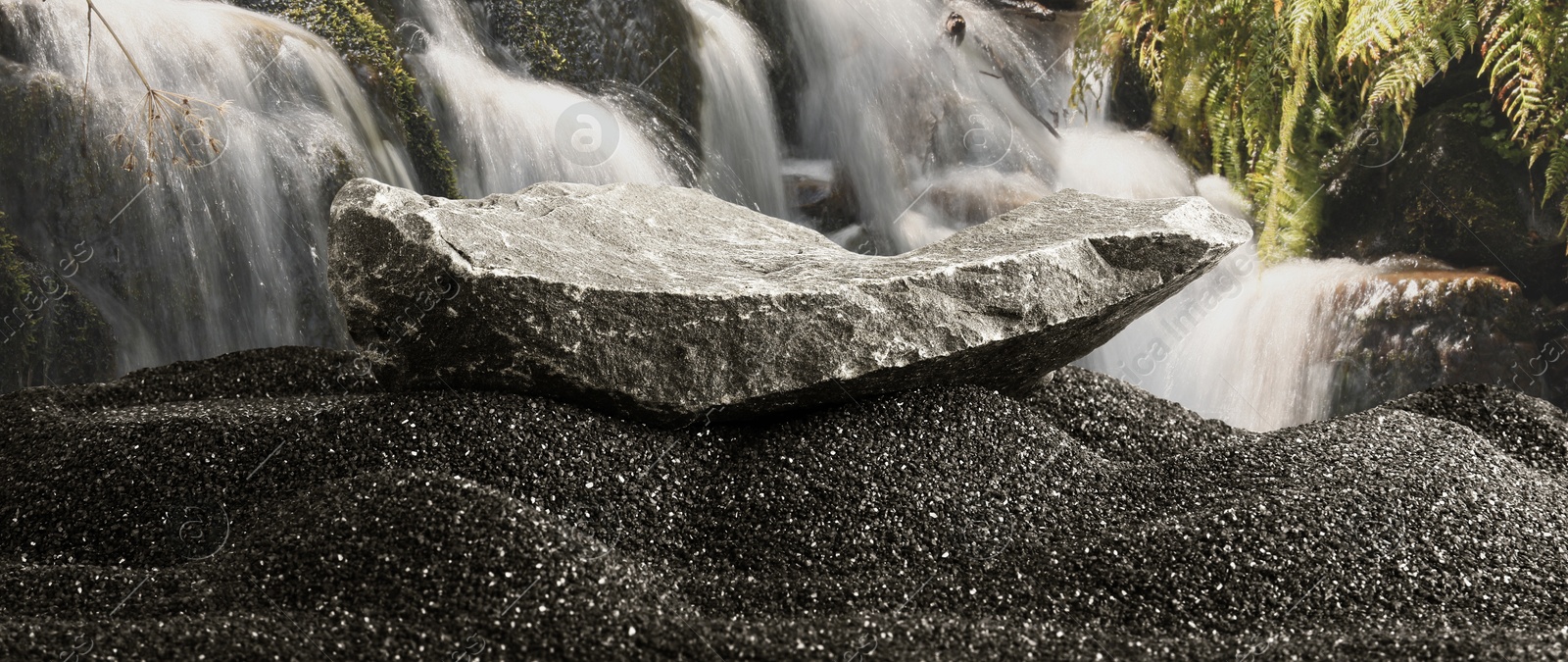 Stone as podium for product presentation on black sand against waterfall, banner design. Stylish promotion poster Image of Stone as podium for product presentation on black sand against waterfall, banner design. Stylish promotion poster