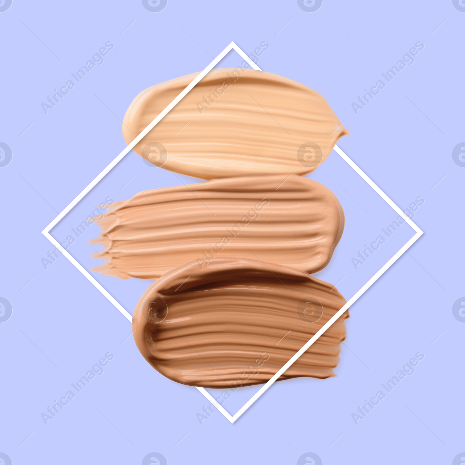 Image of Different shades of foundation and frame on pastel blue background. Color palette of makeup product
