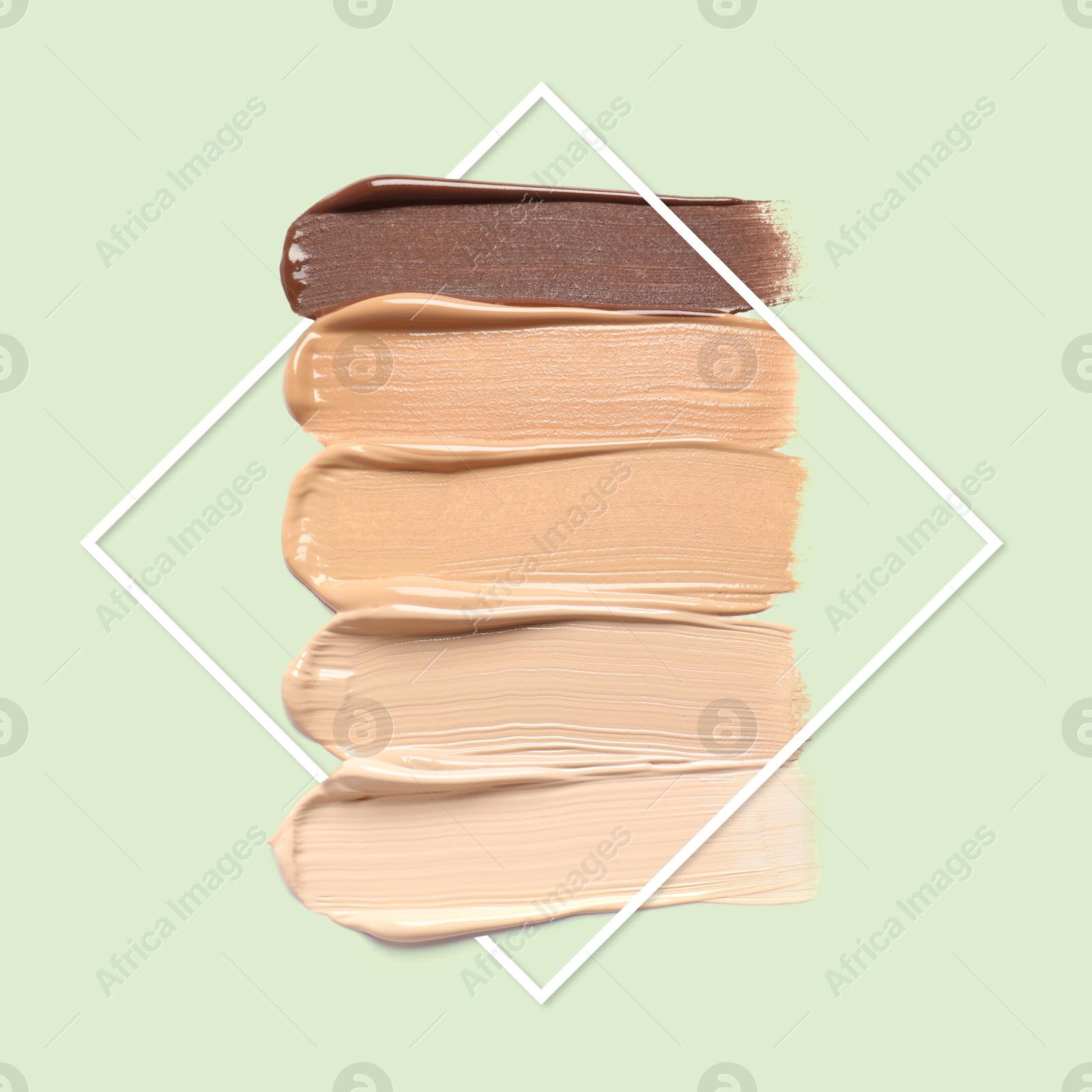 Different shades of foundation and frame on pastel green background. Color palette of makeup product Image of Different shades of foundation and frame on pastel green background. Color palette of makeup product