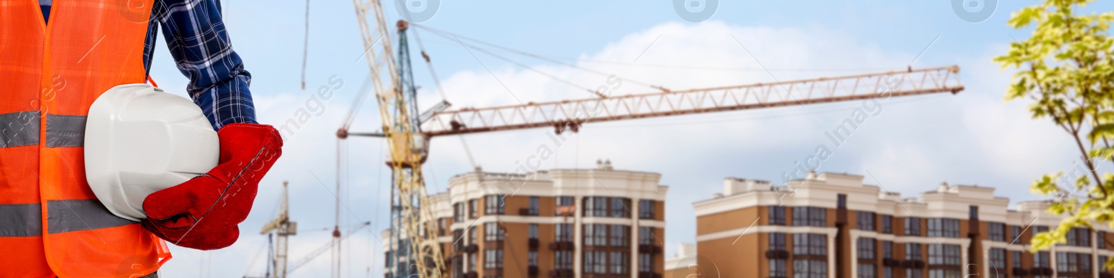 Builder in safety equipment at construction site, closeup. Banner design Image of Builder in safety equipment at construction site, closeup. Banner design