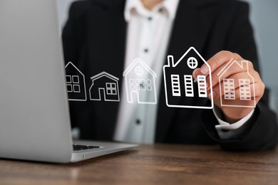 Image of Real estate agent touching house icon on virtual screen at table, closeup. Search for housing