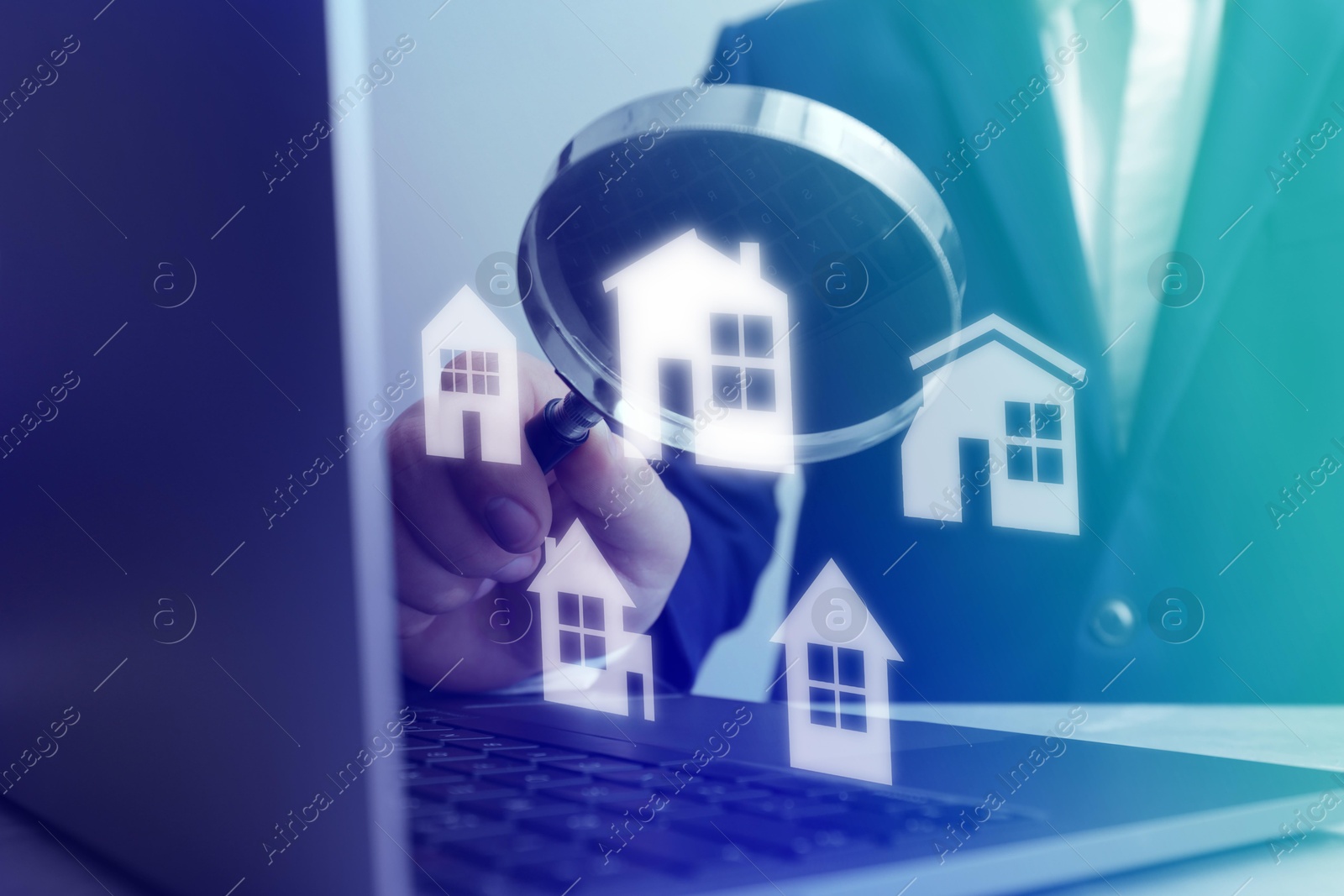 Real estate agent looking at buildings icons with magnifying glass over laptop, closeup. Search for housing Image of Real estate agent looking at buildings icons with magnifying glass over laptop, closeup. Search for housing