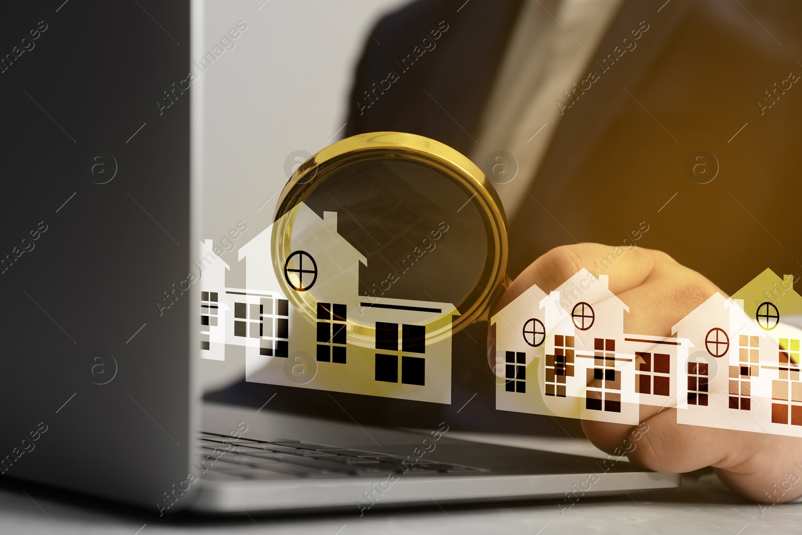 Real estate agent looking at buildings icons with magnifying glass over laptop, closeup. Search for housing Image of Real estate agent looking at buildings icons with magnifying glass over laptop, closeup. Search for housing