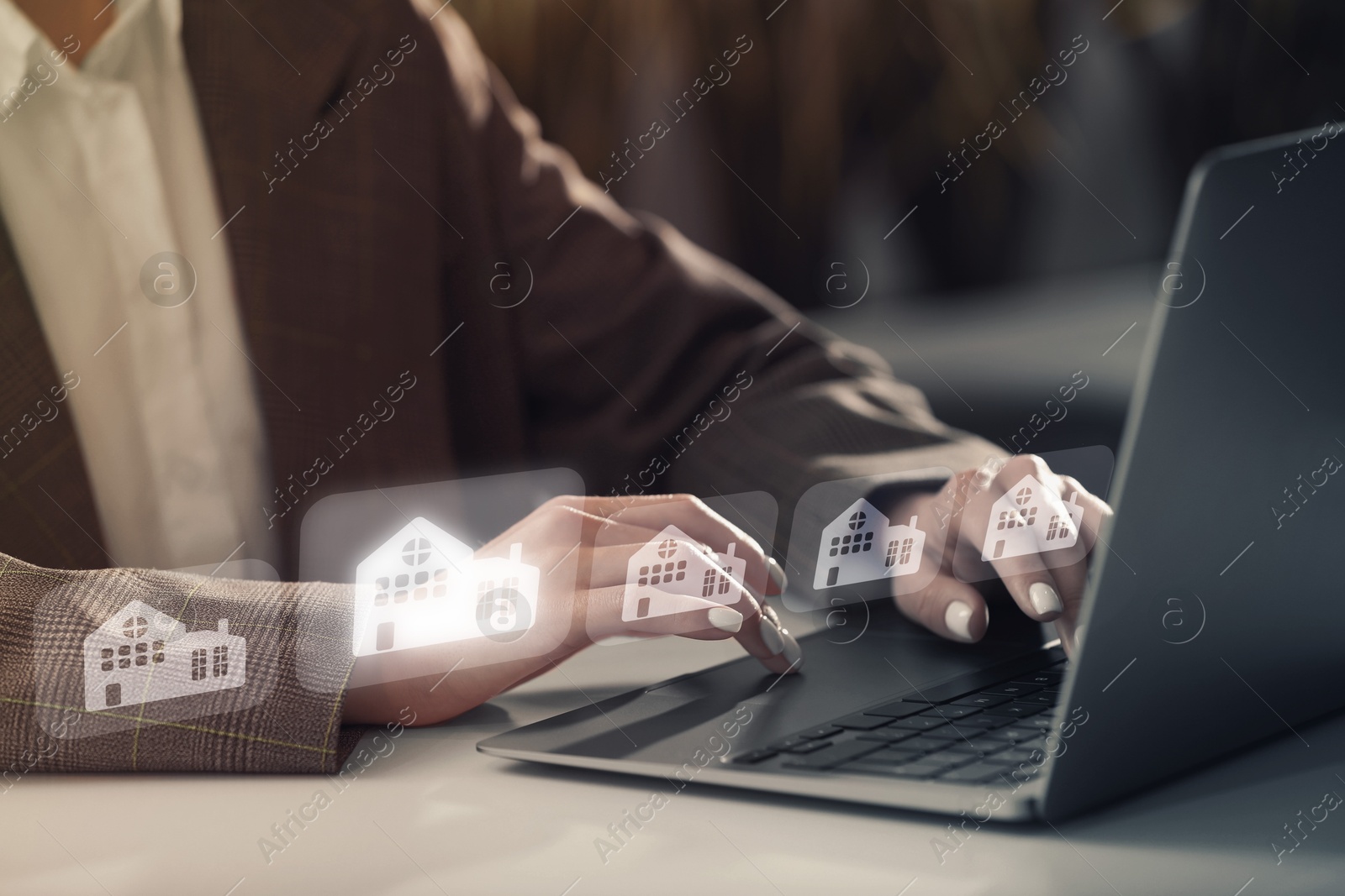 Real estate agent looking for housing via laptop at table, closeup. Illustrations of buildings over devices Image of Real estate agent looking for housing via laptop at table, closeup. Illustrations of buildings over devices