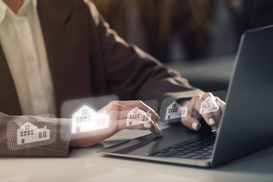 Image of Real estate agent looking for housing via laptop at table, closeup. Illustrations of buildings over devices
