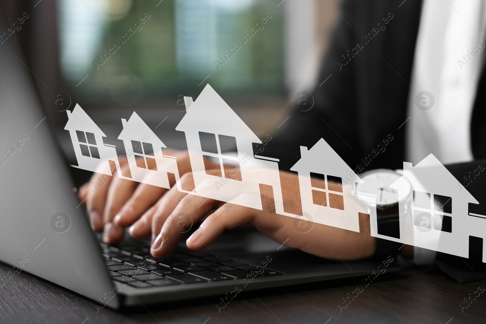 Image of Real estate agent looking for housing via laptop at table indoors, closeup. Illustrations of different buildings over device