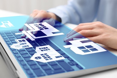 Image of Real estate agent looking for housing via laptop at table, closeup. Illustrations of different buildings over device