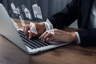Image of Real estate agent looking for housing via laptop at wooden table, closeup. Illustrations of different dwellings over device