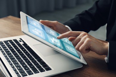 Image of Real estate agent looking for housing via tablet indoors, closeup. Illustrations of buildings on device screen