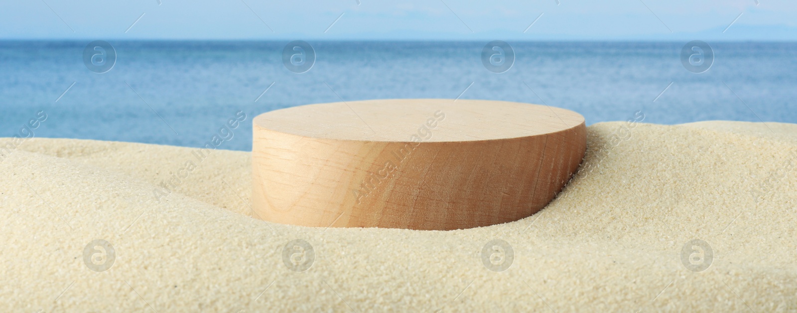 Podium for product promotion on sand near blue sea, banner design. Stylish presentation Image of Podium for product promotion on sand near blue sea, banner design. Stylish presentation