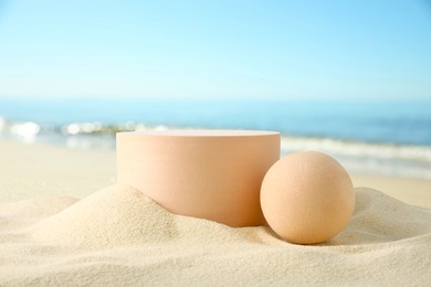 Image of Podium for product presentation. Figures on sand near blue sea. Stylish promotion poster
