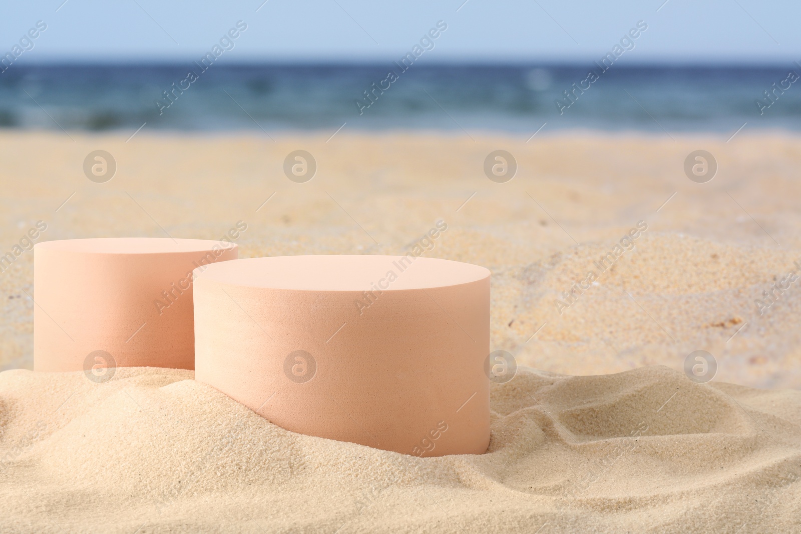 Podium for product presentation. Figures on sand near blue sea. Stylish promotion poster Image of Podium for product presentation. Figures on sand near blue sea. Stylish promotion poster