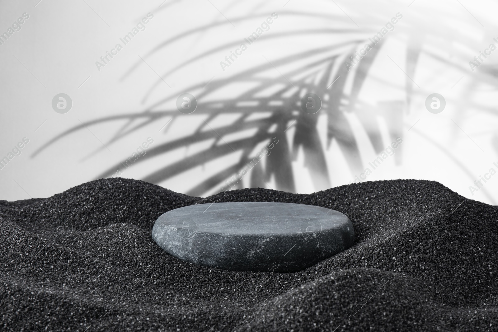Podium for product presentation. Stone on black sand against white background with shadow of leaves. Stylish promotion poster Image of Podium for product presentation. Stone on black sand against white background with shadow of leaves. Stylish promotion poster
