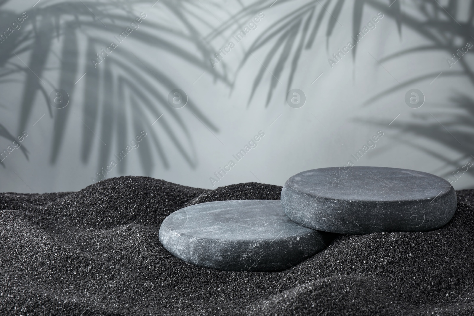 Podium for product presentation. Stones on black sand against grey background with shadow of leaves. Stylish promotion poster Image of Podium for product presentation. Stones on black sand against grey background with shadow of leaves. Stylish promotion poster