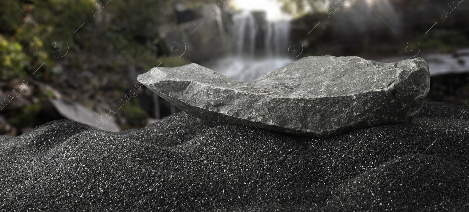 Stone as podium for product presentation on black sand against waterfall, banner design. Stylish promotion poster Image of Stone as podium for product presentation on black sand against waterfall, banner design. Stylish promotion poster