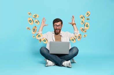 Image of Cryptocurrency. Happy man with laptop on light blue background. Bitcoins flying out of device
