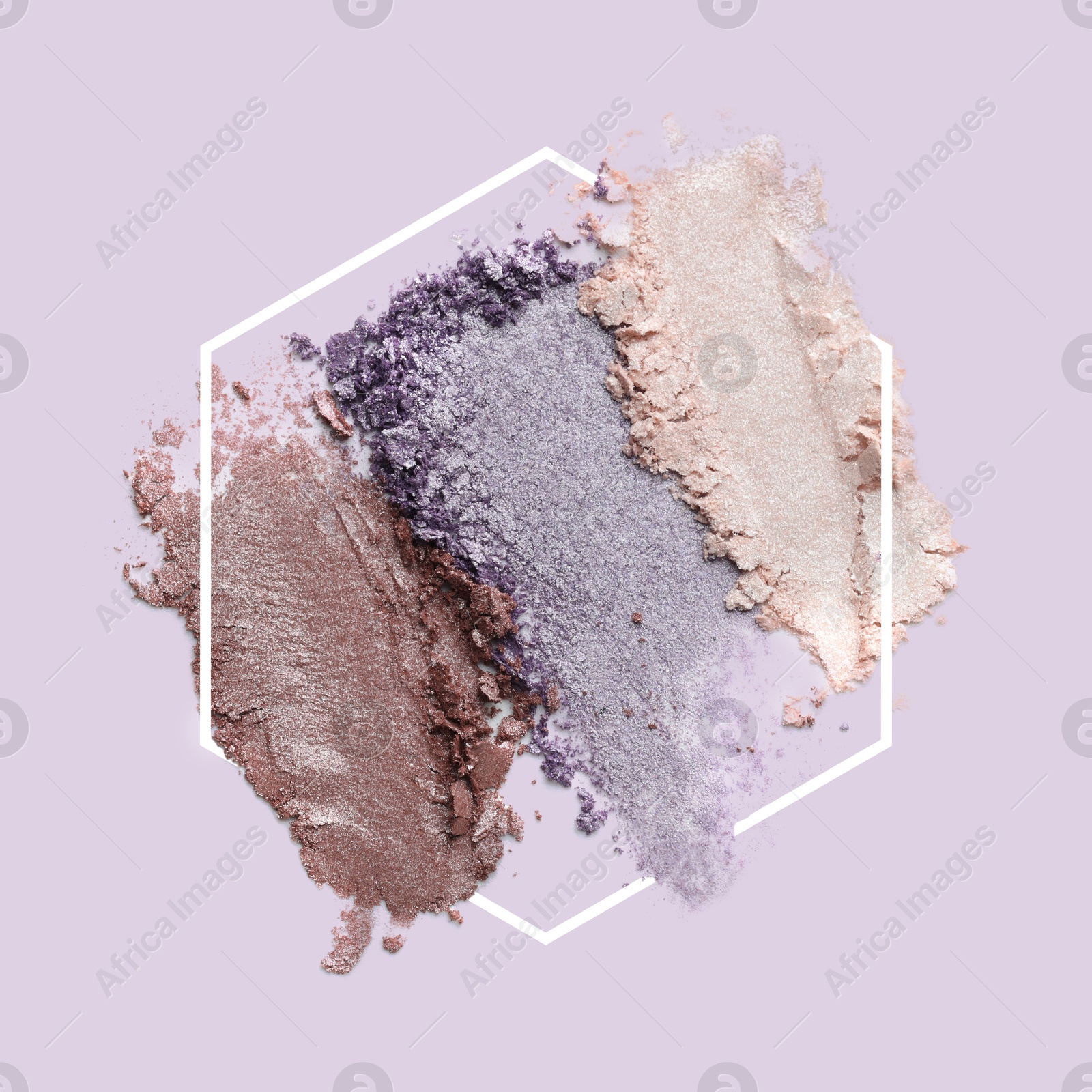 Image of Crushed eye shadows and frame on lavender background. Color palette of makeup product