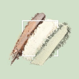 Image of Crushed eye shadows and frame on pastel green background. Color palette of makeup product