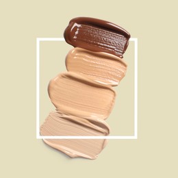 Image of Different shades of foundation and frame on pastel olive background. Color palette of makeup product