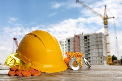 Image of Set of safety equipment on table against construction site