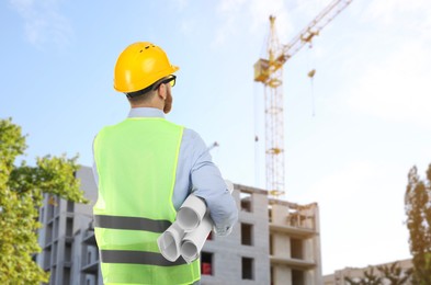 Image of Engineer in safety equipment looking at construction site