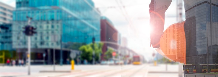 Image of Worker with hard hat, multiple exposure with cityscape. Banner design